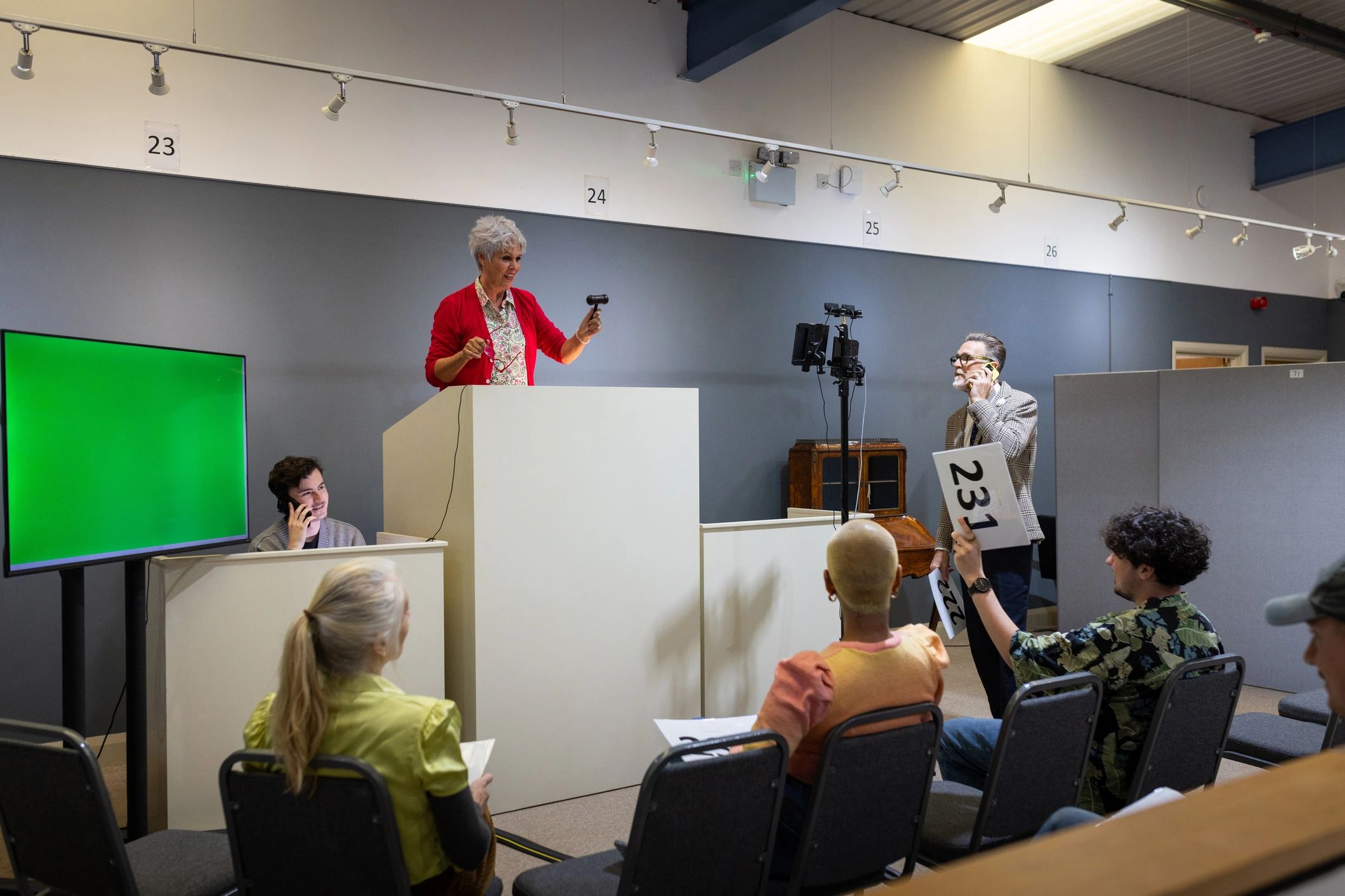 Animated public meeting with raised hands and lively discussion